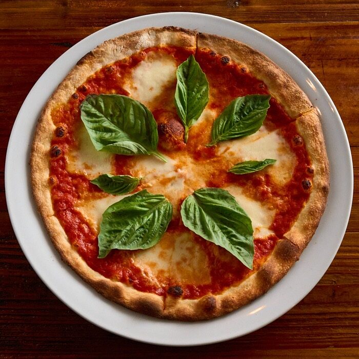 Margherita pizza with tomato sauce, fresh mozzarella and basil leaves